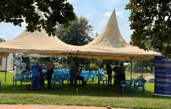 people working under a large tent